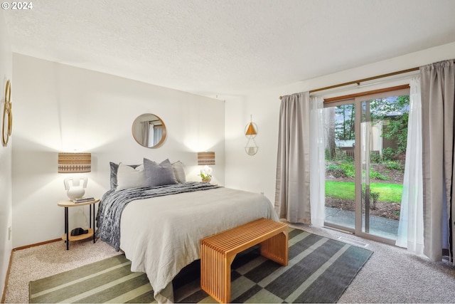 bedroom featuring access to exterior, a textured ceiling, and carpet floors