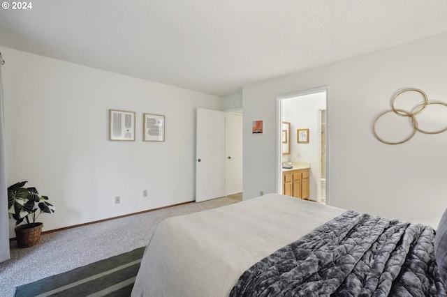 bedroom featuring ensuite bathroom and light colored carpet