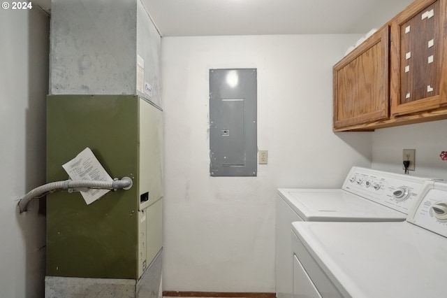 washroom with cabinets, electric panel, separate washer and dryer, and heating unit