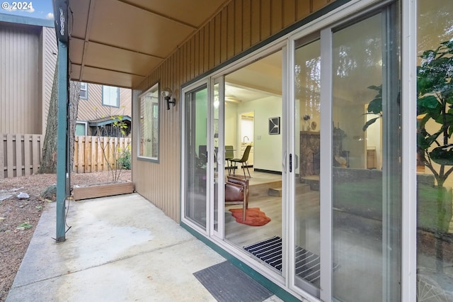 doorway with wood walls and concrete flooring