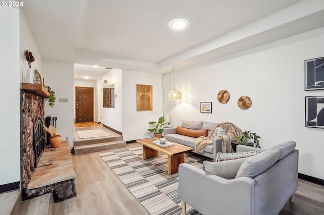 living room with a fireplace and light hardwood / wood-style flooring