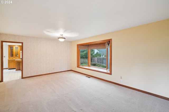 unfurnished room with light carpet