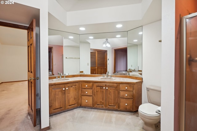 bathroom featuring vanity, toilet, and an inviting chandelier