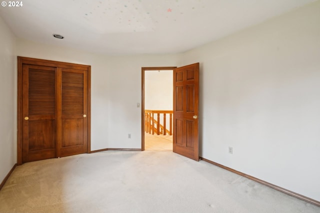 unfurnished bedroom featuring light colored carpet