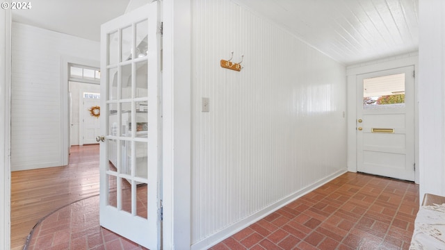 foyer entrance with wood walls