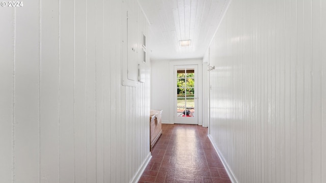 hallway with wood walls