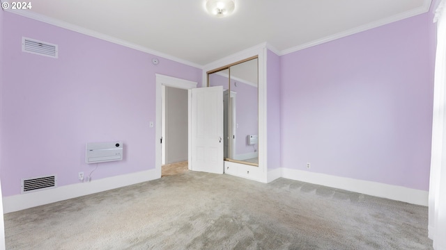 carpeted spare room featuring ornamental molding