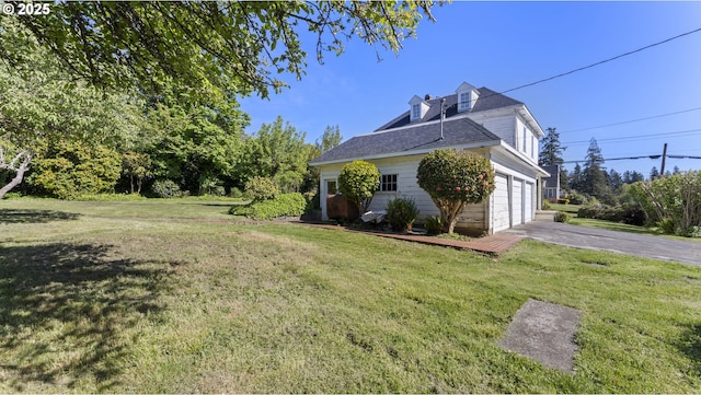 view of property exterior featuring a lawn, roof with shingles, aphalt driveway, and a garage