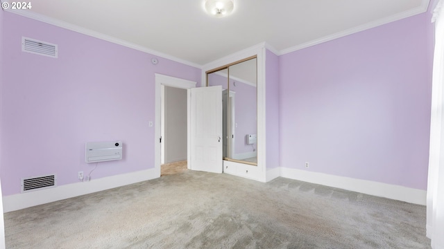 unfurnished bedroom featuring baseboards, carpet flooring, crown molding, and visible vents