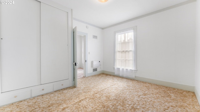carpeted spare room with ornamental molding and visible vents