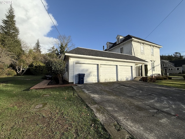 view of property exterior with a yard and a garage