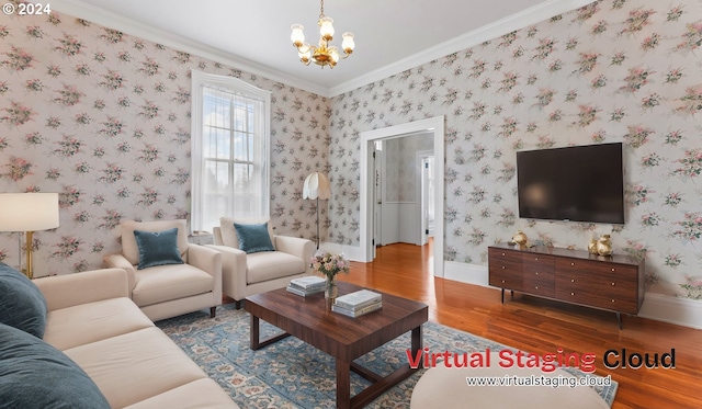 living room with a chandelier, ornamental molding, baseboards, and wood finished floors