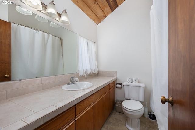 bathroom with vanity, toilet, and vaulted ceiling