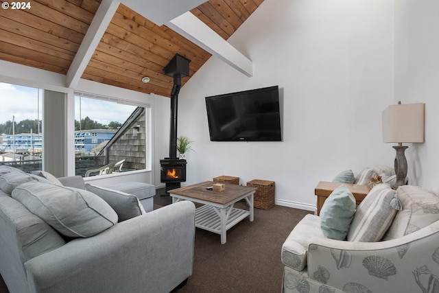 carpeted living room with vaulted ceiling with beams, a wood stove, and wooden ceiling