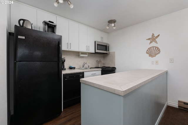 kitchen with kitchen peninsula, white cabinets, and black appliances