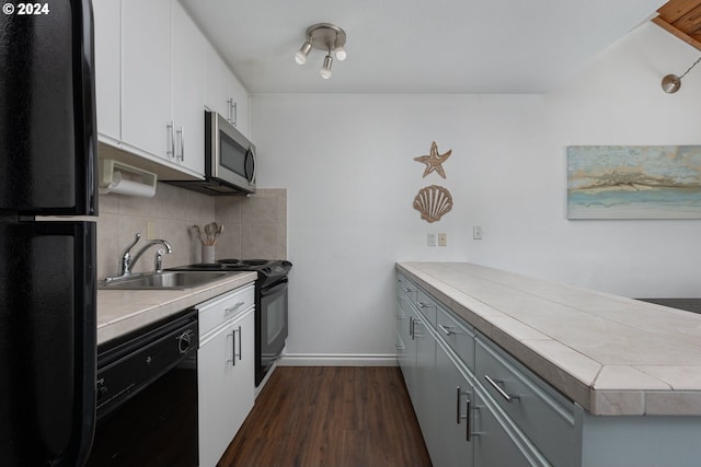 kitchen featuring black appliances, sink, tasteful backsplash, dark hardwood / wood-style flooring, and white cabinetry