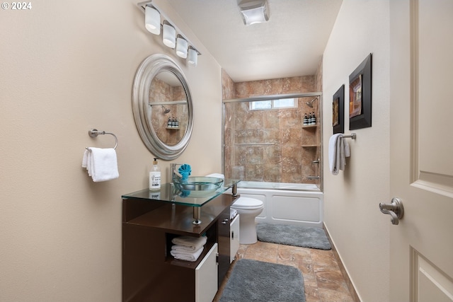 full bathroom with shower / bath combination with glass door, sink, and toilet