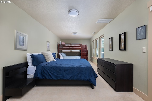 carpeted bedroom featuring a textured ceiling