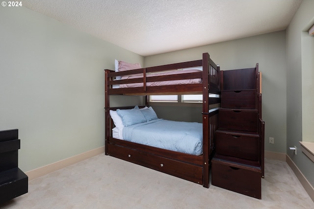 carpeted bedroom with a textured ceiling