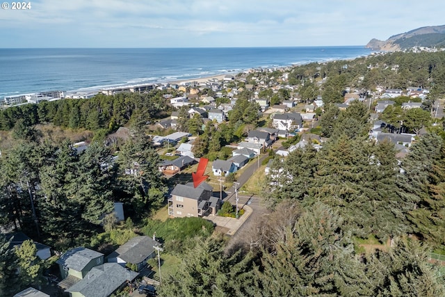 drone / aerial view featuring a water view and a view of the beach