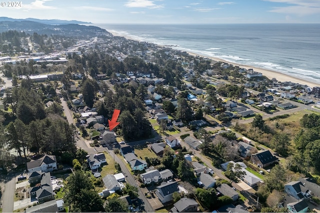 bird's eye view with a water view and a beach view