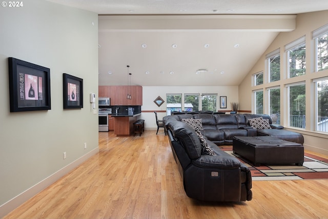 2777 NW Neptune Ave, Lincoln City, OR 97367 - living area featuring high vaulted ceiling, light wood finished floors, baseboards, and beamed ceiling