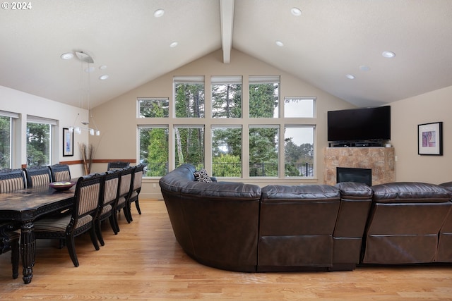 2777 NW Neptune Ave, Lincoln City, OR 97367 - living room featuring a tiled fireplace, beamed ceiling, light wood-style flooring, high vaulted ceiling, and recessed lighting