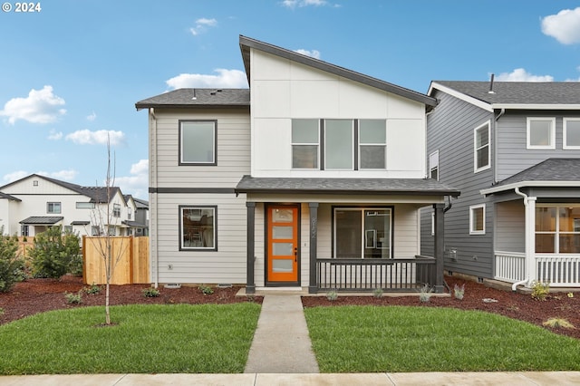 view of front of home with covered porch and a front yard