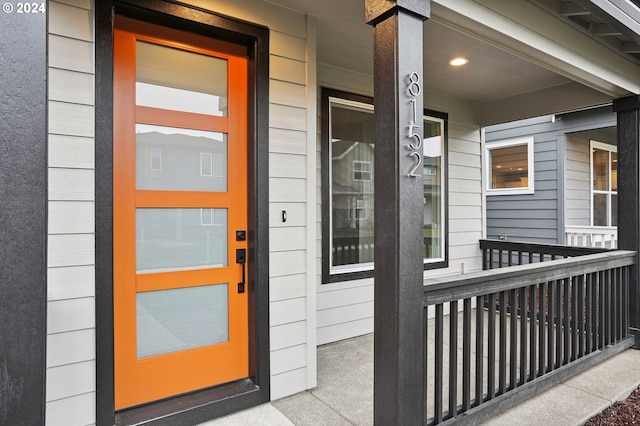 view of exterior entry with covered porch