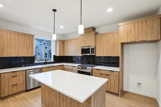 kitchen with a center island, stainless steel appliances, backsplash, pendant lighting, and light hardwood / wood-style floors