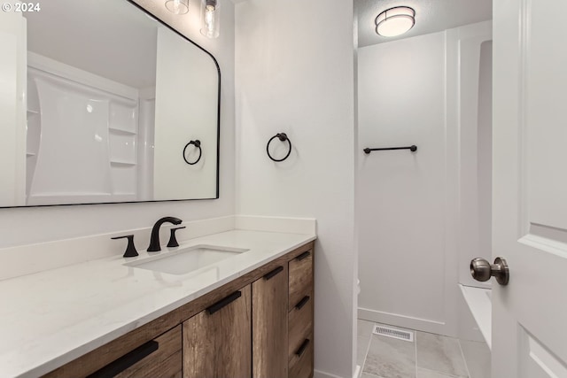 bathroom with tile patterned floors and vanity