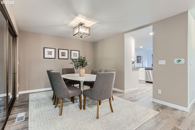 dining space featuring light wood-type flooring