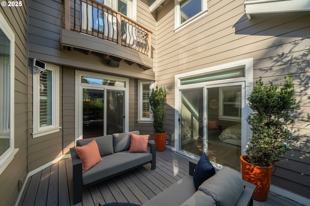 wooden deck with an outdoor living space