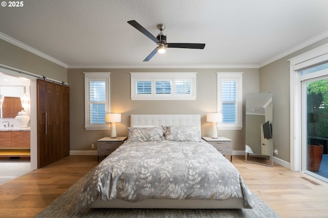 bedroom featuring ceiling fan, a barn door, access to exterior, and light wood-type flooring