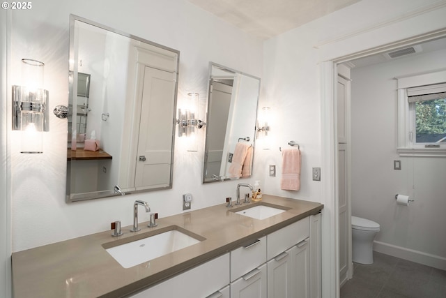 bathroom featuring toilet and vanity