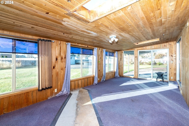 sunroom / solarium with a healthy amount of sunlight and wood ceiling