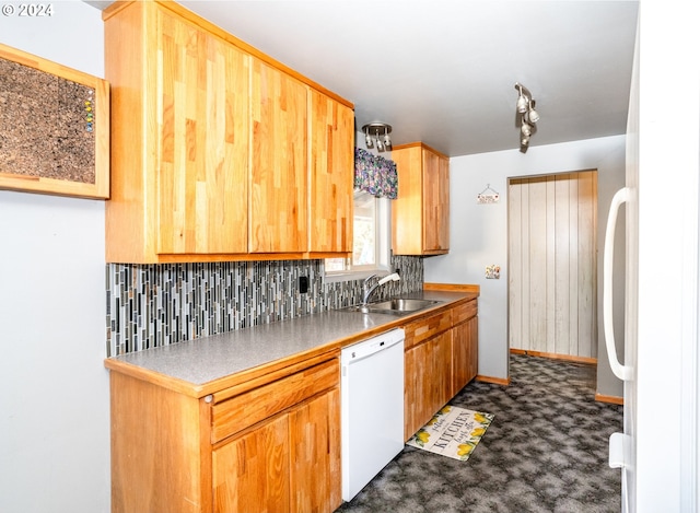 kitchen featuring white appliances, sink, and tasteful backsplash