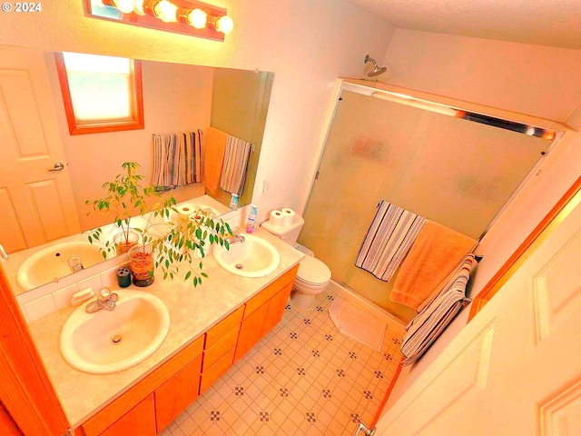 bathroom with an enclosed shower, vanity, and toilet