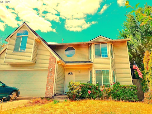 view of front of house featuring a garage and a front lawn