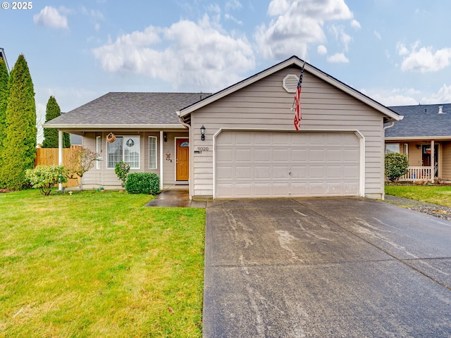 ranch-style home featuring roof with shingles, a front yard, fence, a garage, and driveway