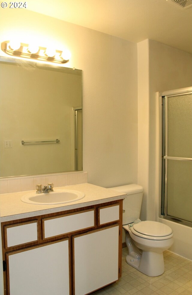 full bathroom featuring vanity, toilet, and enclosed tub / shower combo