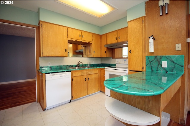 kitchen with kitchen peninsula, sink, white appliances, and light hardwood / wood-style flooring