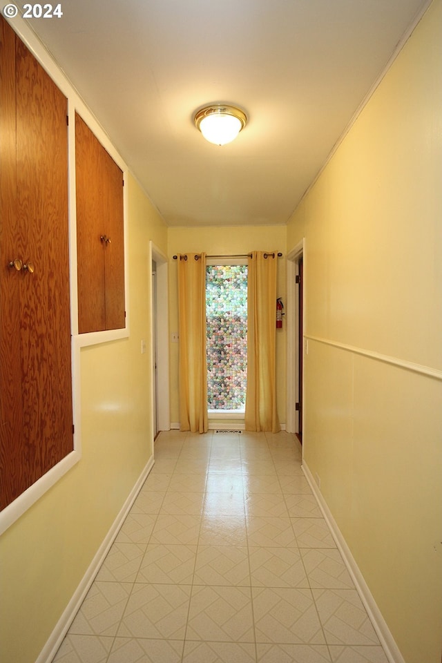 hall with light tile patterned floors