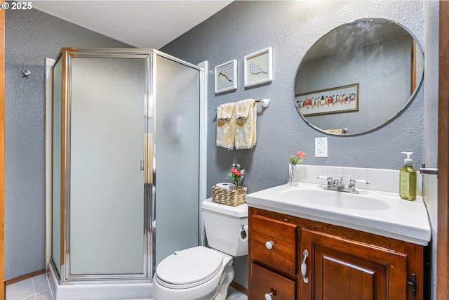 bathroom featuring a textured wall and a stall shower