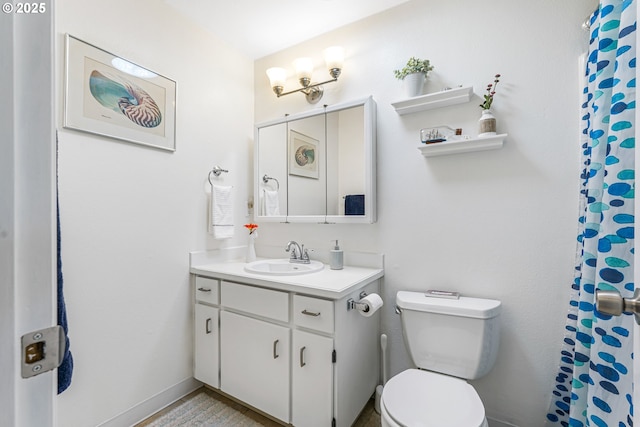 bathroom with curtained shower, baseboards, vanity, and toilet