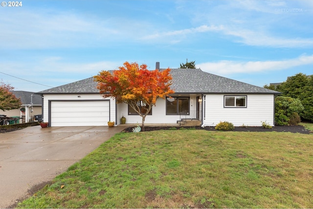 ranch-style house featuring a front yard and a garage