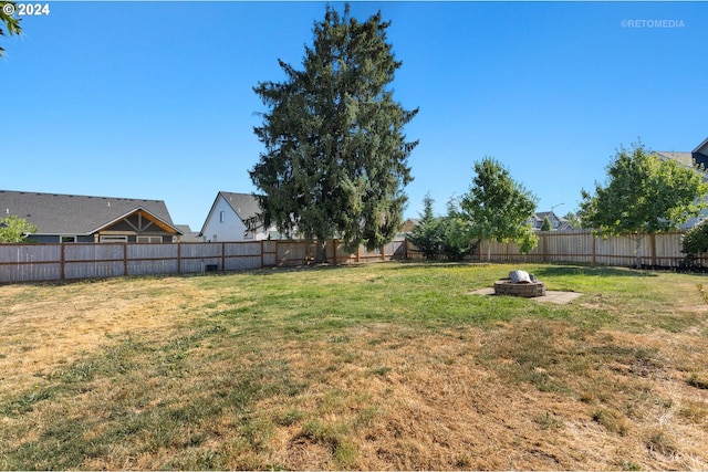 view of yard with an outdoor fire pit