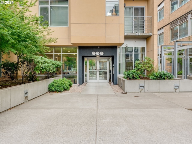 entrance to property with french doors and stucco siding