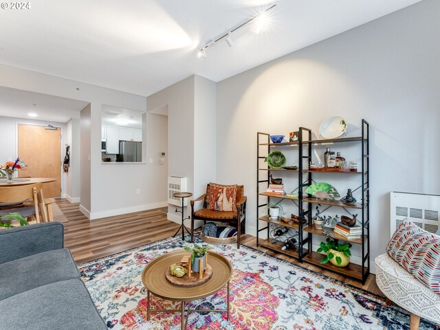 living room with track lighting and hardwood / wood-style flooring