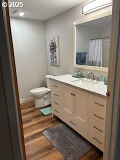 bedroom featuring multiple windows and hardwood / wood-style flooring